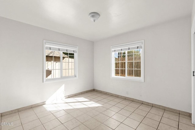 tiled empty room with a healthy amount of sunlight