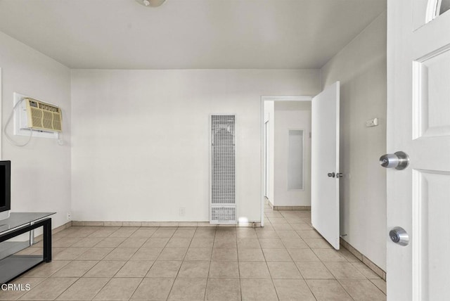 tiled spare room with a wall unit AC