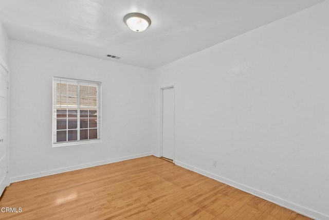 empty room with light hardwood / wood-style floors