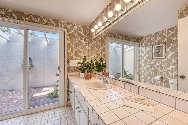 bathroom featuring vanity, tile patterned floors, plenty of natural light, and toilet