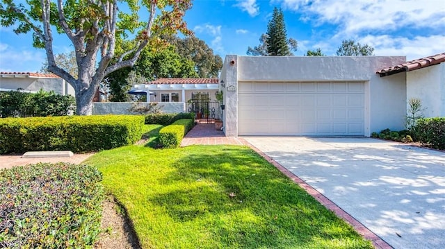 mediterranean / spanish house with a front yard and a garage