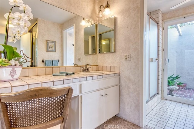 bathroom with tile patterned flooring, an enclosed shower, and vanity