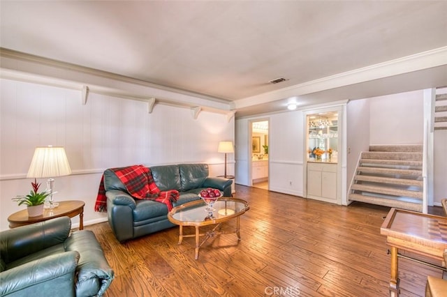 living room with ornamental molding and wood-type flooring