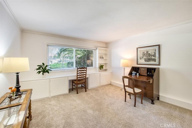 carpeted home office featuring built in desk and ornamental molding