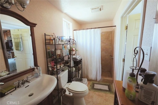 bathroom featuring walk in shower, toilet, and sink