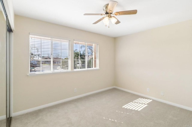 carpeted empty room with ceiling fan