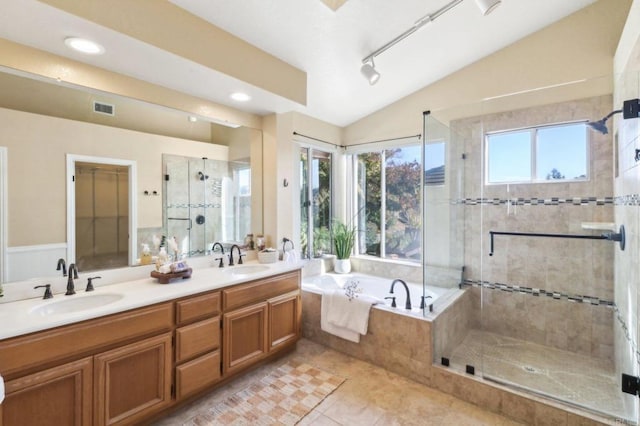 bathroom with tile patterned floors, vaulted ceiling, plenty of natural light, and independent shower and bath