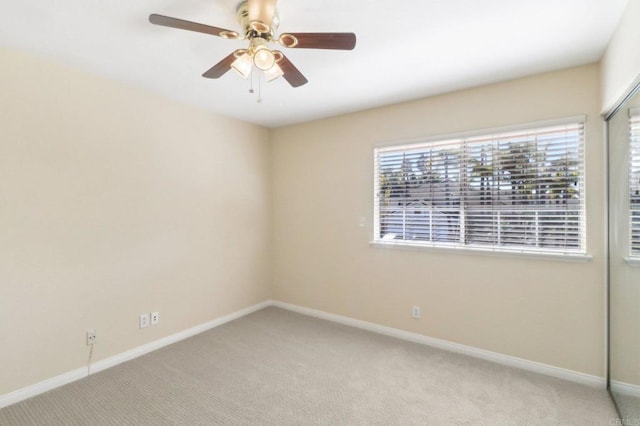 empty room with light colored carpet and ceiling fan