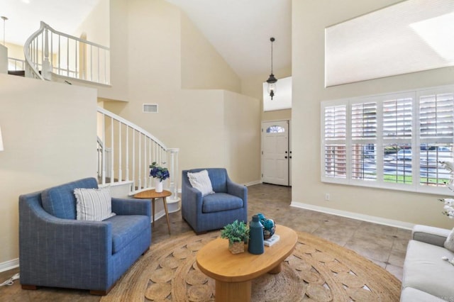 living room featuring light tile patterned floors and high vaulted ceiling