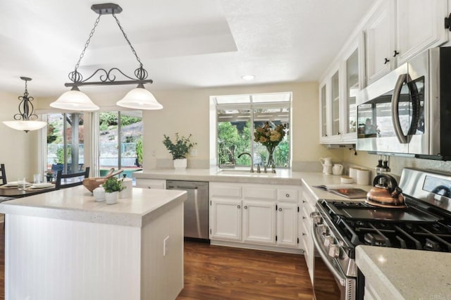 kitchen with white cabinets, appliances with stainless steel finishes, a healthy amount of sunlight, and sink