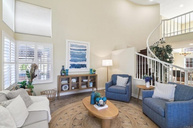 living room with a towering ceiling, hardwood / wood-style flooring, and a wealth of natural light