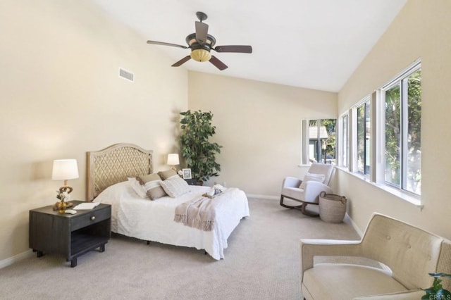 bedroom with ceiling fan, lofted ceiling, and light carpet