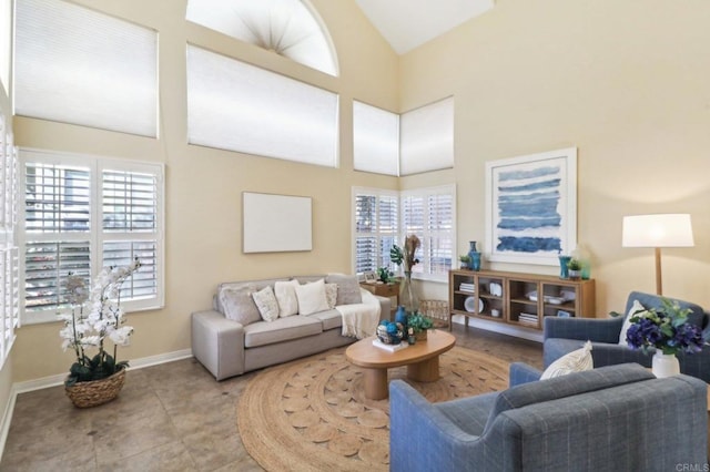 tiled living room featuring high vaulted ceiling and a healthy amount of sunlight