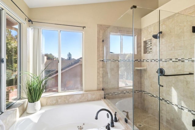 bathroom featuring lofted ceiling and plus walk in shower