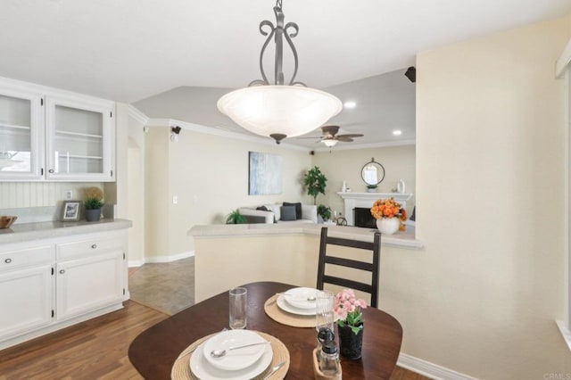 dining area featuring ceiling fan, dark hardwood / wood-style floors, and ornamental molding