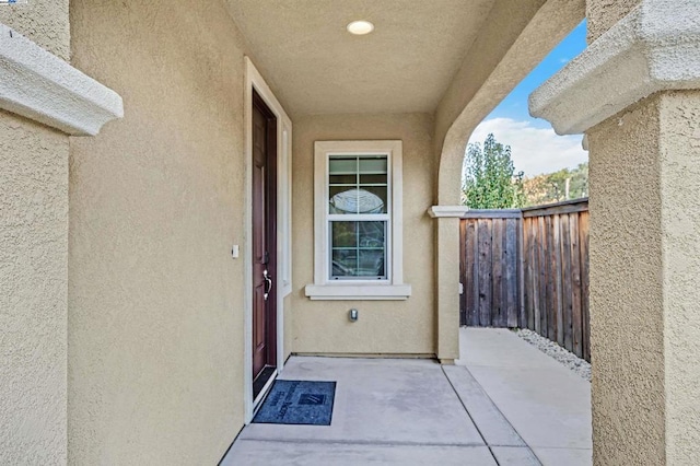 view of exterior entry featuring a patio area