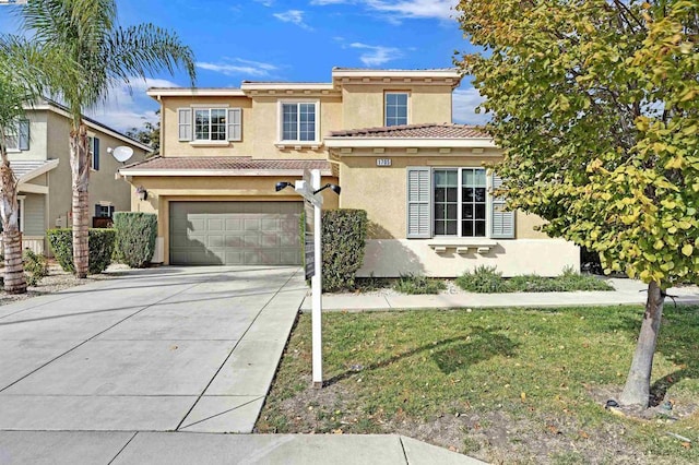 mediterranean / spanish house featuring a garage and a front lawn