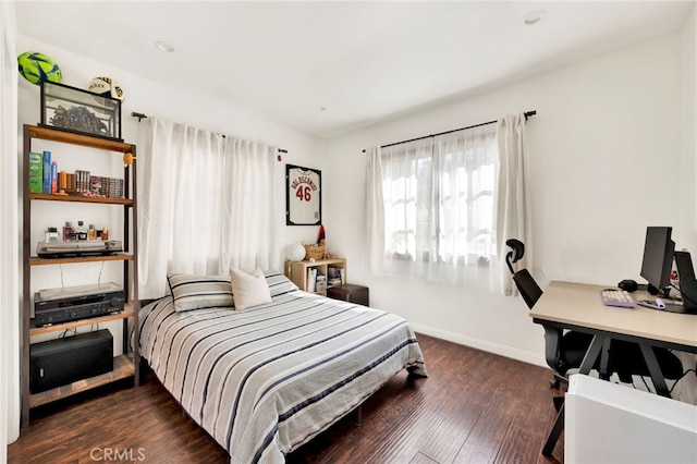 bedroom with dark hardwood / wood-style flooring