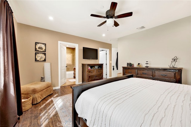 bedroom with ceiling fan, dark hardwood / wood-style floors, and connected bathroom