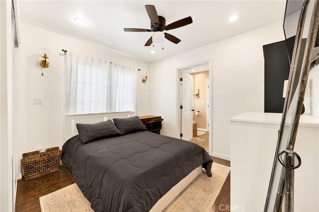 bedroom featuring connected bathroom, dark hardwood / wood-style floors, and ceiling fan