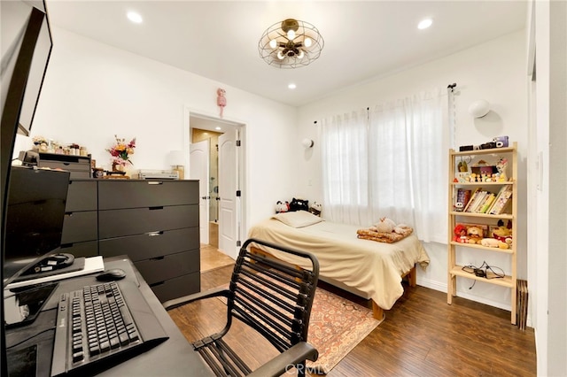 bedroom with dark hardwood / wood-style floors