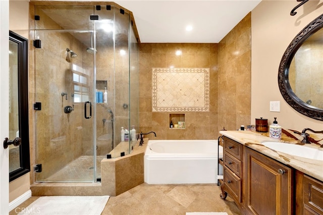 bathroom featuring tile patterned flooring, vanity, tile walls, and plus walk in shower