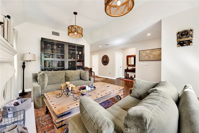 living room with a fireplace, dark wood-type flooring, and lofted ceiling