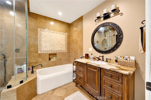 bathroom with vanity, tile walls, and independent shower and bath