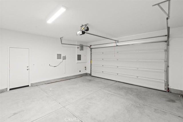 garage featuring a garage door opener and baseboards