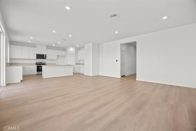 unfurnished living room featuring light wood-type flooring