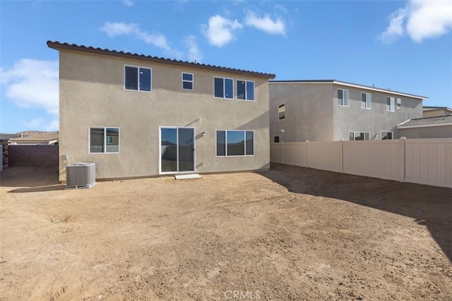 rear view of property with cooling unit