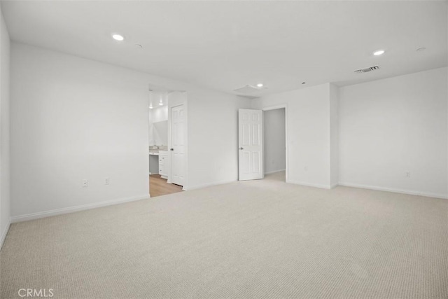 unfurnished room with light colored carpet