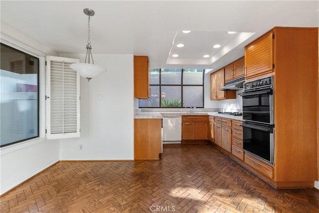 kitchen featuring dark parquet floors, black double oven, sink, decorative light fixtures, and dishwasher