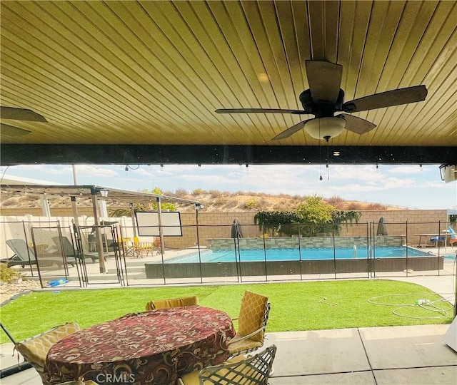 view of home's community with a lawn, a swimming pool, and a patio