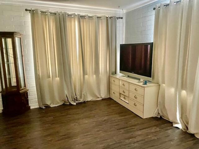 unfurnished bedroom featuring dark hardwood / wood-style floors and ornamental molding