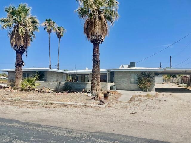 single story home featuring a carport