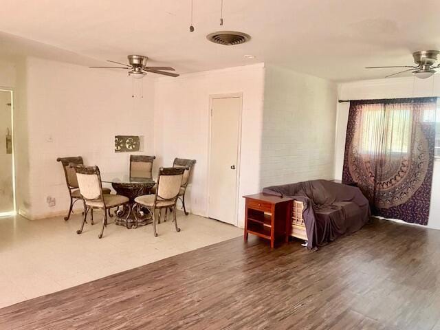 dining area with ceiling fan and wood-type flooring