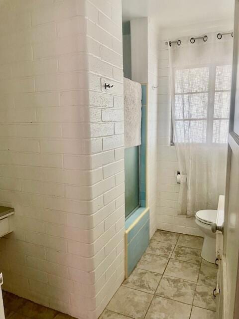 bathroom with tile patterned floors and toilet