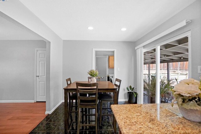 dining space with dark wood-type flooring