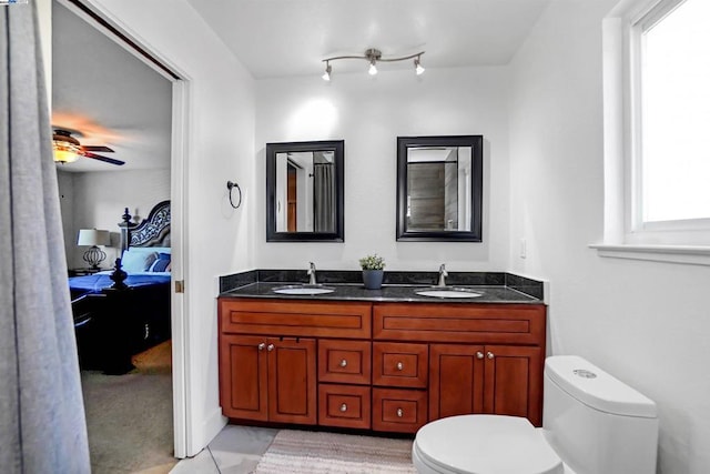 bathroom with vanity, a wealth of natural light, ceiling fan, and toilet