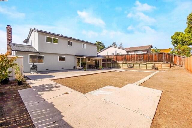 back of house with a patio