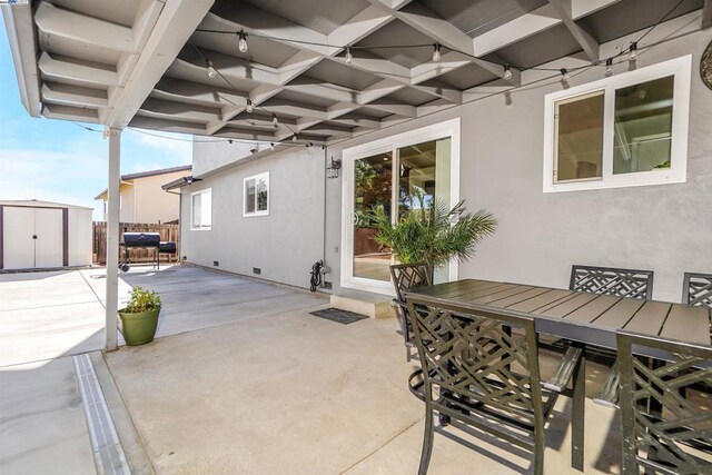 view of patio / terrace with a shed