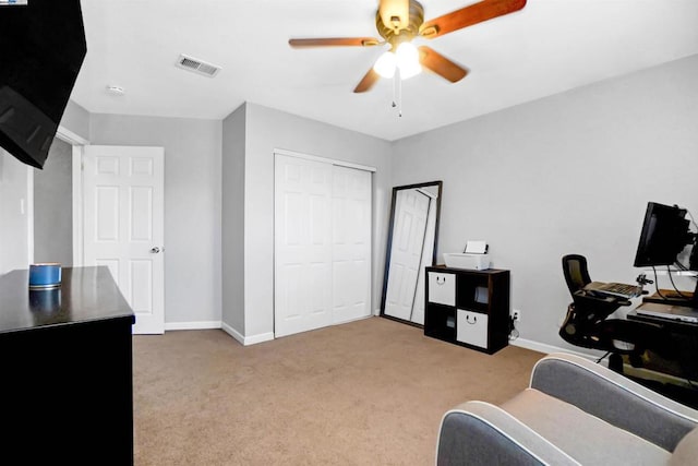 office featuring light carpet and ceiling fan