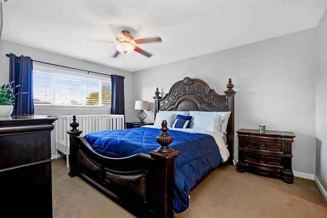 carpeted bedroom with radiator and ceiling fan