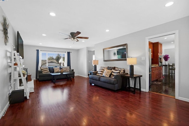 living room featuring dark hardwood / wood-style floors and ceiling fan