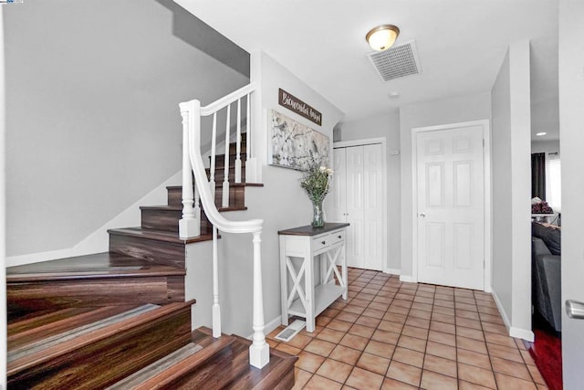 entryway with light tile patterned floors