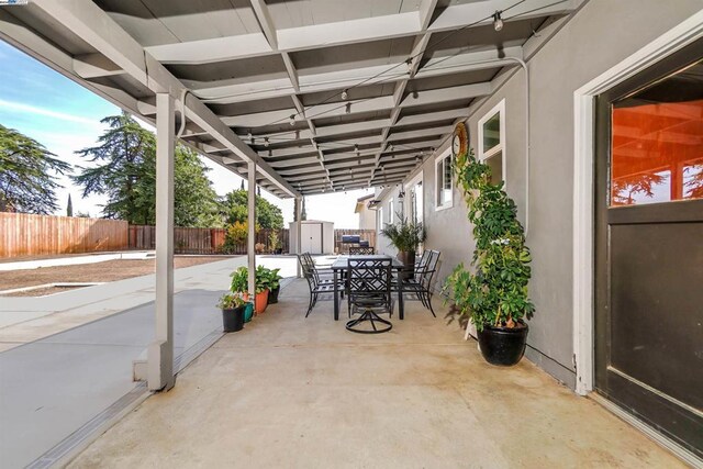 view of patio featuring a shed