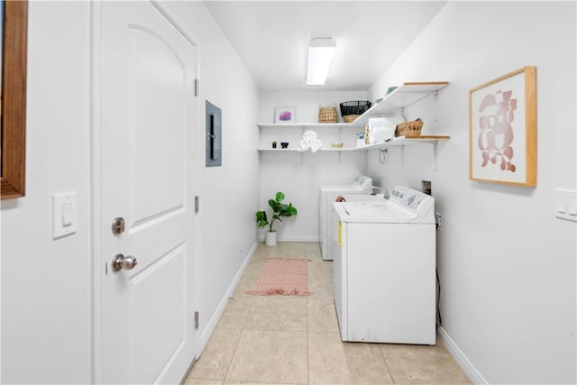 washroom with electric panel, separate washer and dryer, and light tile patterned flooring