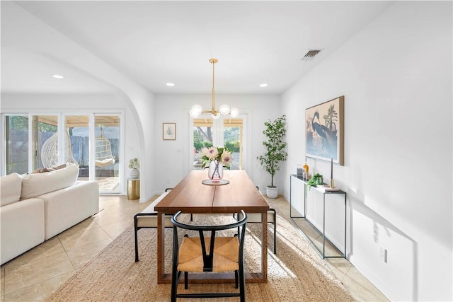 dining area featuring a wealth of natural light and a notable chandelier