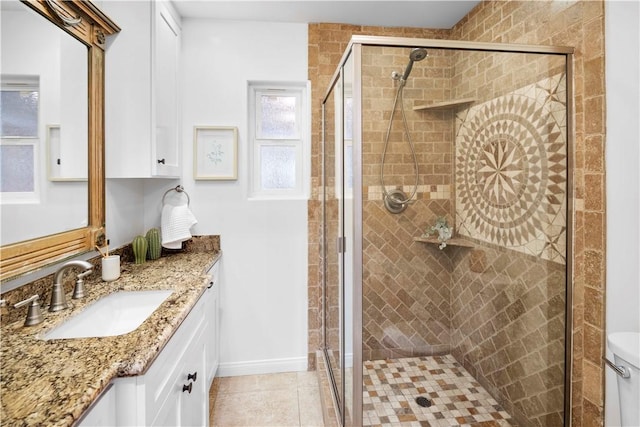 bathroom with tile patterned flooring, vanity, toilet, and a shower with door